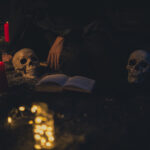 witchcraft-arrangement-with-candle-lights-dark