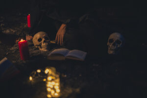 witchcraft-arrangement-with-candle-lights-dark